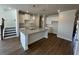 Open-concept kitchen boasts a large island, granite countertops, and modern pendant lighting at 226 Depot Landing Rd # 56, Auburn, GA 30011