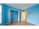 Small bedroom with light blue walls and wood flooring at 3599 Woodbriar Cir # G, Tucker, GA 30084