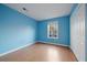 Simple bedroom with blue walls and wood flooring at 3599 Woodbriar Cir # G, Tucker, GA 30084
