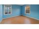 Well-lit bedroom with light blue walls and wood-look floors at 3599 Woodbriar Cir # G, Tucker, GA 30084