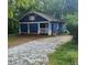 Charming one story house with blue siding and a gravel driveway at 1116 Northwest Nw Dr, Atlanta, GA 30318