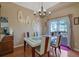 Bright dining room with glass table, chandelier, and access to a deck at 3643 Southland Ne Dr, Buford, GA 30519