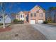 Brick two-story house with attached two-car garage and manicured landscaping at 3643 Southland Ne Dr, Buford, GA 30519