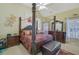 Opulent main bedroom with a stately four poster bed and sitting area at 3643 Southland Ne Dr, Buford, GA 30519