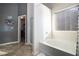 Bright bathroom features a soaking tub, tiled floor, and walk-in closet access at 529 Dasheill Ln, Atlanta, GA 30349