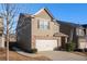 Charming two-story home with a stone-accented facade and attached two-car garage at 529 Dasheill Ln, Atlanta, GA 30349