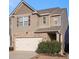 Charming two-story home with a stone-accented facade and attached two-car garage at 529 Dasheill Ln, Atlanta, GA 30349