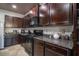 Kitchen featuring dark cabinetry, stainless steel appliances, and granite countertops at 529 Dasheill Ln, Atlanta, GA 30349