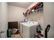 A functional laundry room features a washer and dryer, and extra storage shelf at 529 Dasheill Ln, Atlanta, GA 30349