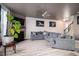 Spacious living room with a gray sectional sofa, fireplace, and hardwood floors at 529 Dasheill Ln, Atlanta, GA 30349