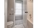 Clean bathroom with toilet, tub and window at 7715 Bold Springs Xing, Cumming, GA 30041