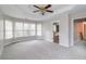 Bright bedroom with carpeted floors, large windows and access to ensuite bathroom at 7715 Bold Springs Xing, Cumming, GA 30041