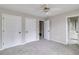 Bedroom with carpet, ceiling fan and multiple closets at 7715 Bold Springs Xing, Cumming, GA 30041