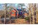 Brick house with a dark roof and landscaping at 7715 Bold Springs Xing, Cumming, GA 30041
