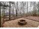 Brick firepit in a fenced backyard with gravel at 7715 Bold Springs Xing, Cumming, GA 30041