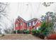 Two story red brick house with dark shutters at 7715 Bold Springs Xing, Cumming, GA 30041