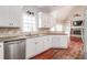 White kitchen cabinets, granite counters, and stainless steel appliances at 7715 Bold Springs Xing, Cumming, GA 30041