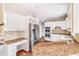 Modern kitchen with granite countertops and stainless steel appliances at 7715 Bold Springs Xing, Cumming, GA 30041