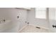 Convenient laundry room with tile flooring and built-in shelving at 7715 Bold Springs Xing, Cumming, GA 30041