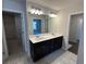 Bathroom with a double sink vanity, white countertop, and modern lighting fixtures at 222 Depot Landing Rd # 58, Auburn, GA 30011