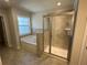 Bathroom showcasing a glass-enclosed shower and a soaking tub with a tiled surround at 222 Depot Landing Rd # 58, Auburn, GA 30011