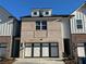 Charming brick townhome featuring dormer windows and an attached two-car garage at 222 Depot Landing Rd # 58, Auburn, GA 30011