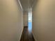 View of a hallway with hardwood floors leading to a room with natural light at 222 Depot Landing Rd # 58, Auburn, GA 30011