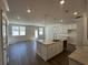 Open-concept kitchen featuring an island, granite countertops, and stainless steel fixtures at 222 Depot Landing Rd # 58, Auburn, GA 30011