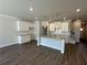 Open-concept kitchen featuring an island, granite countertops, stainless steel fixtures, and modern cabinets at 222 Depot Landing Rd # 58, Auburn, GA 30011