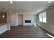 Spacious living room featuring hardwood floors, a modern fireplace, and lots of natural light at 222 Depot Landing Rd # 58, Auburn, GA 30011