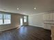 View of a living room with windows and hardwood floors at 222 Depot Landing Rd # 58, Auburn, GA 30011