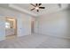 Large main bedroom with tray ceiling, carpet, and ensuite bathroom at 222 Depot Landing Rd # 58, Auburn, GA 30011