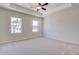 Main bedroom with high ceilings, ceiling fan, and large windows at 222 Depot Landing Rd # 58, Auburn, GA 30011