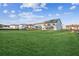 Large backyard with green grass and homes in background at 2799 Porches Ln, Dacula, GA 30019