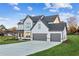 Two-story farmhouse with gray accents and a three-car garage at 2799 Porches Ln, Dacula, GA 30019