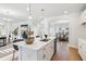Open concept kitchen with white cabinets, island, and stainless steel appliances at 2799 Porches Ln, Dacula, GA 30019