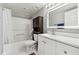 Bathroom with white vanity, tub and dark wood cabinet at 795 Hammond Dr # 1407, Atlanta, GA 30328