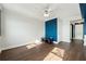 Bedroom with hardwood floors, ceiling fan and blue accent wall at 795 Hammond Dr # 1407, Atlanta, GA 30328