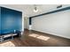 Bedroom with hardwood floors, ceiling fan and blue accent wall at 795 Hammond Dr # 1407, Atlanta, GA 30328