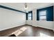 Bedroom with hardwood floors and two windows at 795 Hammond Dr # 1407, Atlanta, GA 30328