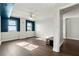 Bright bedroom with hardwood floors, ceiling fan, and blue accent wall at 795 Hammond Dr # 1407, Atlanta, GA 30328