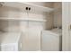 Convenient laundry room with washer, dryer, and shelving at 795 Hammond Dr # 1407, Atlanta, GA 30328