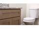 Bright bathroom features a granite countertop and a white toilet at 195 Ridgecrest Way, Stockbridge, GA 30281