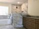 Modern primary bathroom featuring double vanity, tiled shower, and separate soaking tub at 195 Ridgecrest Way, Stockbridge, GA 30281
