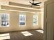 This main bedroom boasts a trey ceiling, a ceiling fan, and natural light from three windows at 195 Ridgecrest Way, Stockbridge, GA 30281