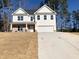 Charming two-story home with a brick-accented porch and a pristine two-car garage at 195 Ridgecrest Way, Stockbridge, GA 30281