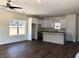 Bright living room view showcasing the wood flooring and kitchen with white cabinets at 195 Ridgecrest Way, Stockbridge, GA 30281