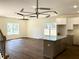 Bright living room features wood floors and a modern light fixture over the kitchen island at 195 Ridgecrest Way, Stockbridge, GA 30281