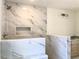 Tiled walk-in shower with rain shower head, built-in niche, and marble-look tile at 195 Ridgecrest Way, Stockbridge, GA 30281