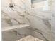 Walk-in shower featuring marble-look tile, mosaic tile floor and corner bench at 195 Ridgecrest Way, Stockbridge, GA 30281